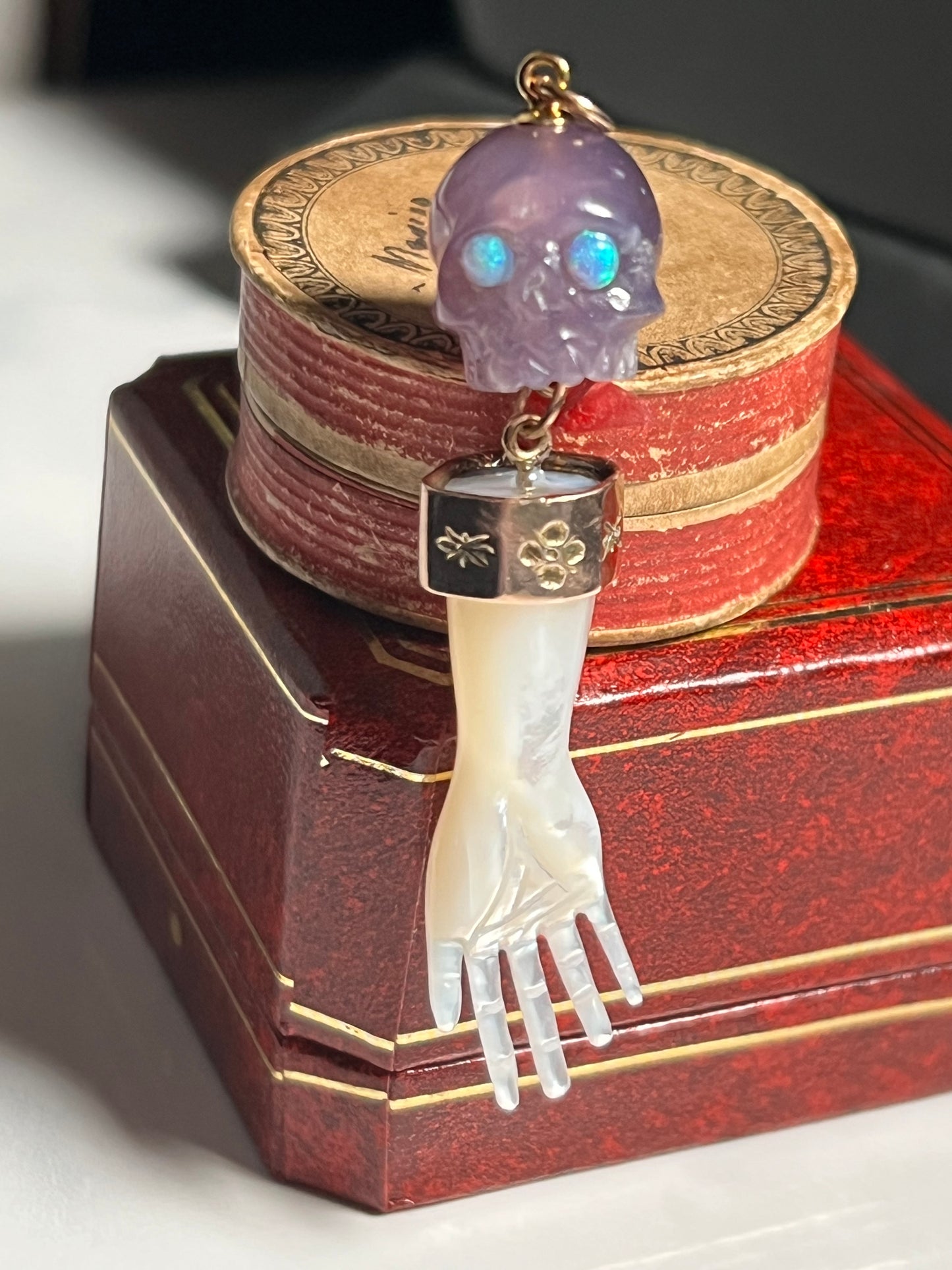 Iolite Gemstone Skull w/ Opal Eyes and Mother of Pearl Hand